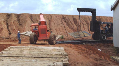 Building an access road in preparation of handling a heavy crusher installation where a special rigger forklift had to be utilized due to the limited space which did not allow access by a crane.