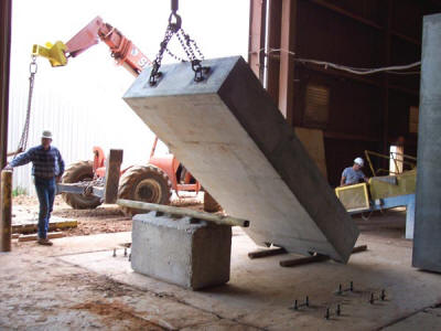 Installation of four 28,000 lb precast concrete plinths.