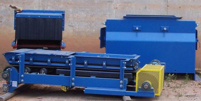 Prefabricated "slinger" conveyor used to feed a rotary clay dryer (front center).  Head box (back left) and baffled crusher feed inlet used to spread material over the full width of the rotor on a 70" wide crusher for high moisture clay (back right).