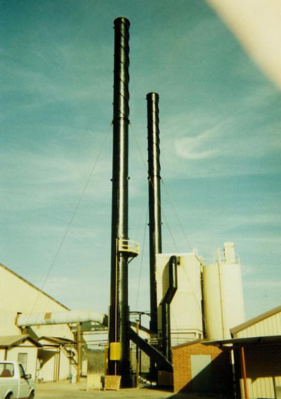Two 120' tall double walled exhaust stacks after refurbishment.
