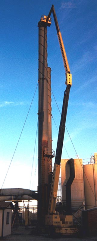 Installing a replacement liner breach and cone section into one of two 120' tall exhaust stacks.  Each stack was refurbished while erect utilizing a 131' tall man lift for access as well as a 60 ton capacity hydraulic truck crane for lifting.