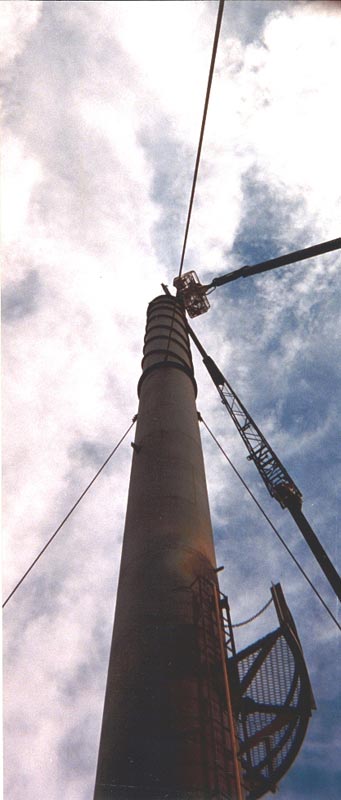 Installing a replacement liner breach and cone section into one of two 120' tall exhaust stacks.  Each stack was refurbished while erect utilizing a 131' tall man lift for access as well as a 60 ton capacity hydraulic truck crane for lifting.