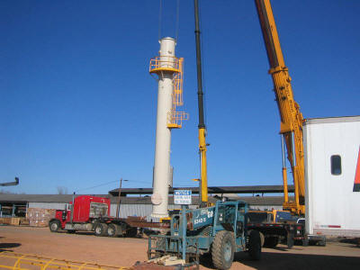 Lifting the base section of a 101' freestanding exhaust stack which was pre-assembled with test ports, access caged ladder and 1/3 circumference testing platform.