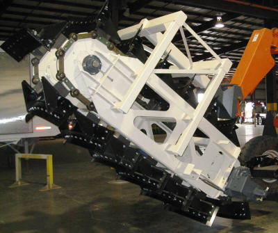 Demonstration reclaimer unit for a large cantilever half portal reclaim system or a bridge reclaim and storage system.
